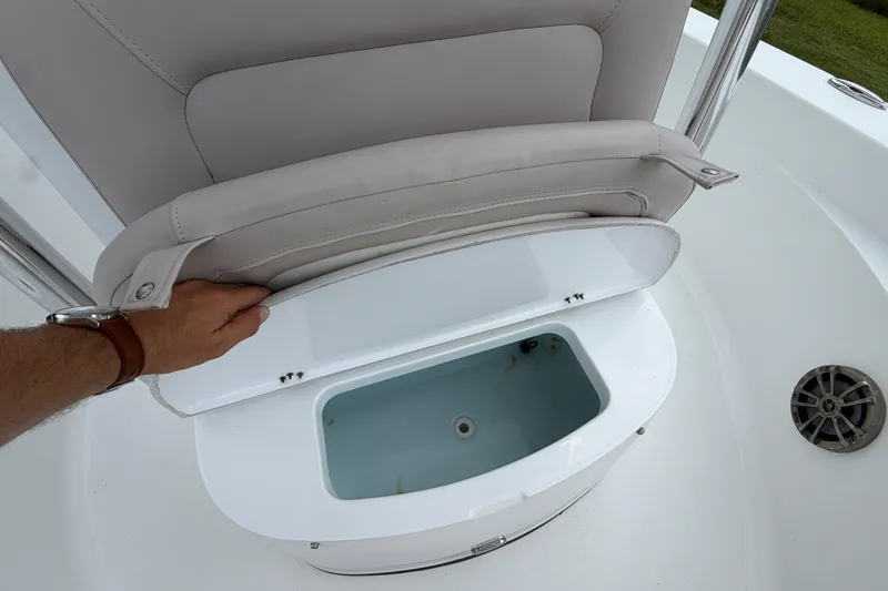 Slide: The Image of 2019 Sportsman Masters 227 Bay Boat seat storage compartment open, revealing interior. - 6