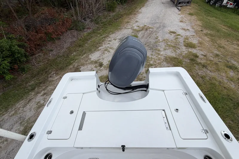 Slide: The Image of 2019 Sportsman Masters 227 Bay Boat with outboard motor, viewed from above on a grassy path. - 12
