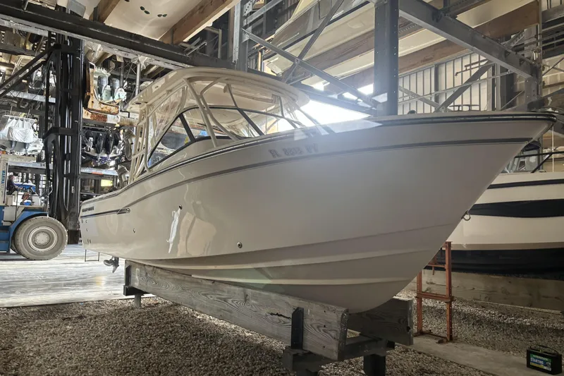 Slide: The Image of 2015 Grady-White Freedom 275 boat stored indoors on a rack. - 4