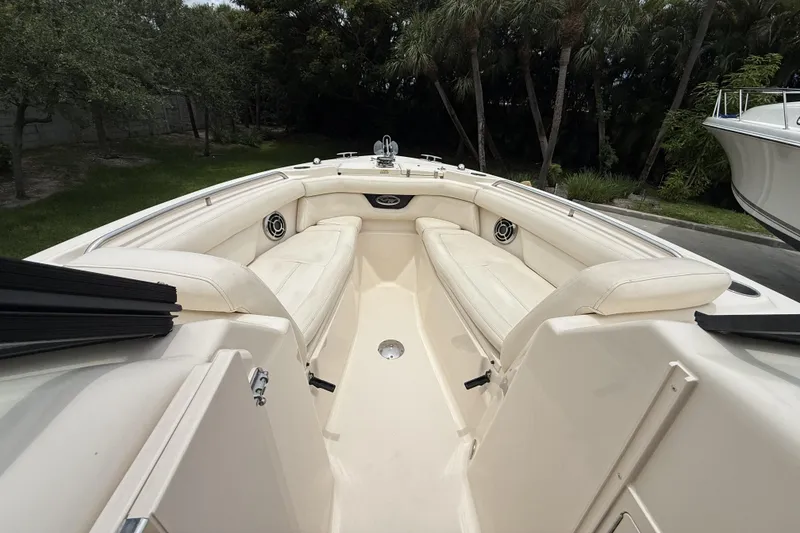 Slide: The Image of 2015 Grady-White Freedom 275 boat interior with white seating and speakers. - 12