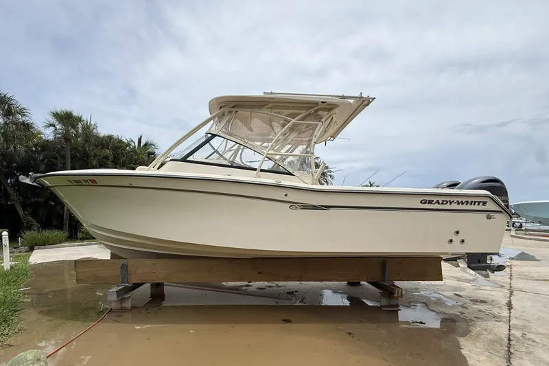 Slide: The Image of 2015 Grady-White Freedom 275 boat on display, side view, outdoors. - 1