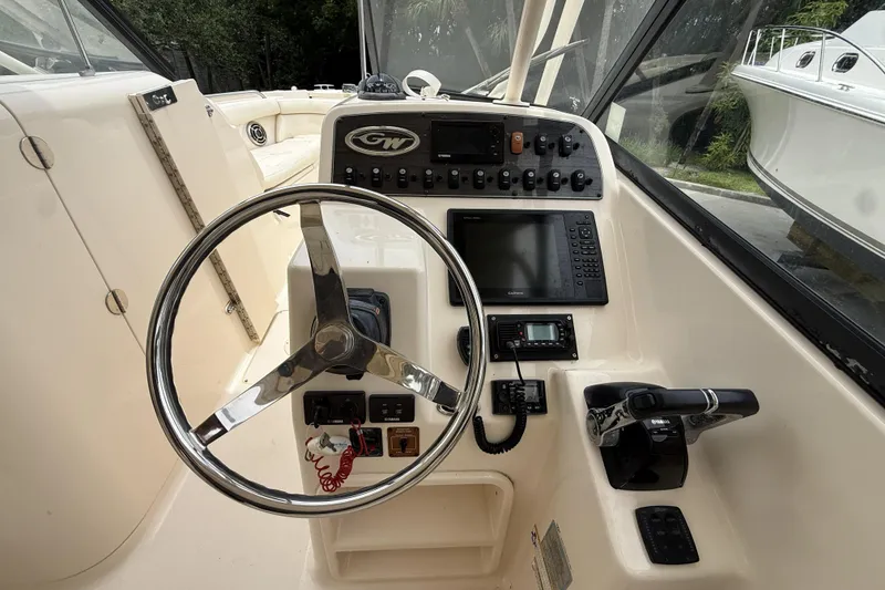 Slide: The Image of 2015 Grady-White Freedom 275 boat helm with steering wheel and control panel. - 14
