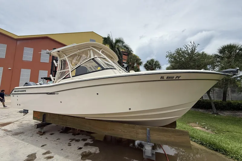 Slide: The Image of 2015 Grady-White Freedom 275 boat on display, parked outdoors near a building. - 3