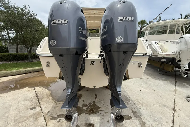 Slide: The Image of 2015 Grady-White Freedom 275 boat with twin Yamaha 200 engines, docked outdoors. - 6