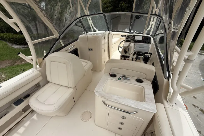 Slide: The Image of Interior of 2015 Grady-White Freedom 275 boat with seating and helm controls. - 9
