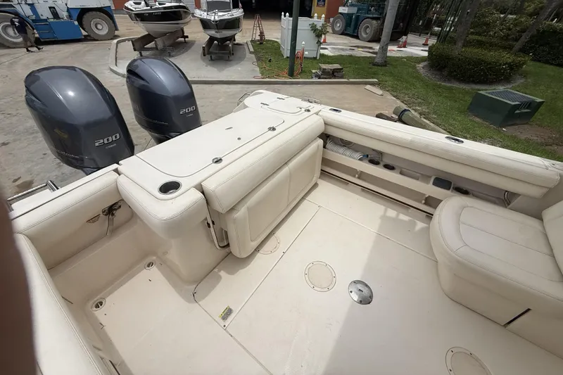 Slide: The Image of 2015 Grady-White Freedom 275 boat interior with dual 200 horsepower engines. - 10