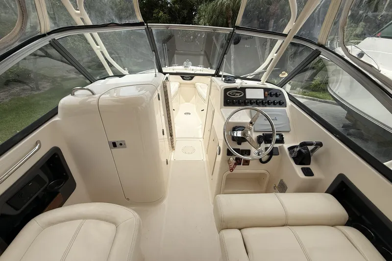 Slide: The Image of 2015 Grady-White Freedom 275 boat interior with steering wheel and control panel. - 11