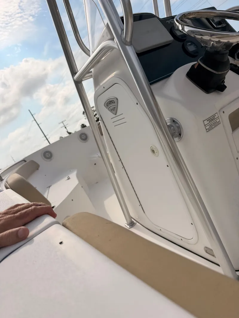 Slide: The Image of The image shows the cockpit of a 2016 Tidewater 220 LXF boat with a helm station. - 8