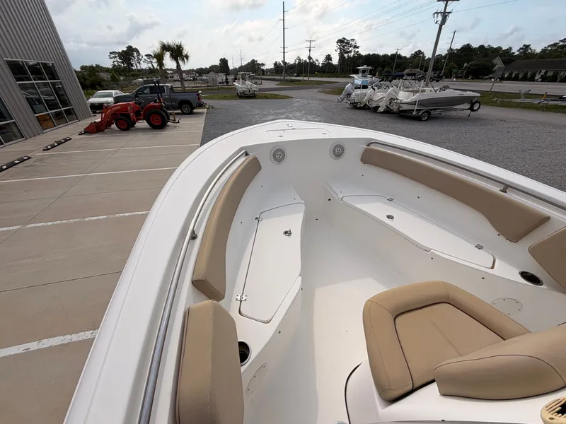 Slide: The Image of The image shows the bow of a Tidewater 220 LXF boat with beige seating. - 11