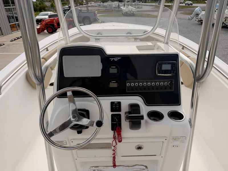 Slide: The Image of The image shows the helm of a 2016 Tidewater 220 LXF boat. - 9