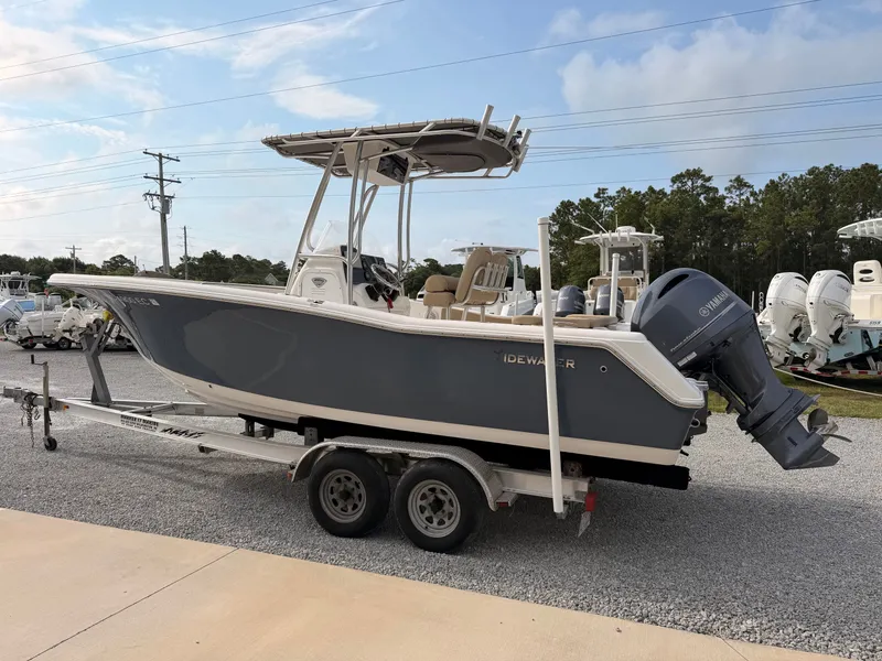Slide: The Image of A gray 2016 Tidewater 220 LXF boat on a trailer in a gravel lot. - 4
