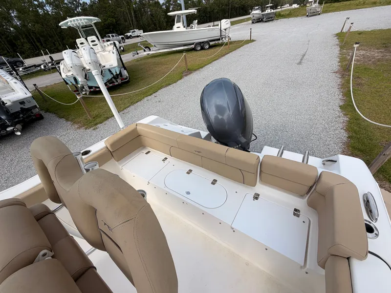 Slide: The Image of The image shows the stern of a Tidewater 220 LXF boat with beige seating and an outboard motor. - 13