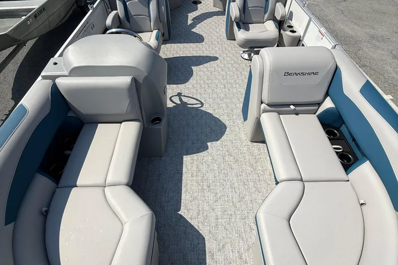 Slide: The Image of 2026 Berkshire 22RFX LE pontoon boat interior with plush seating and cup holders. - 9