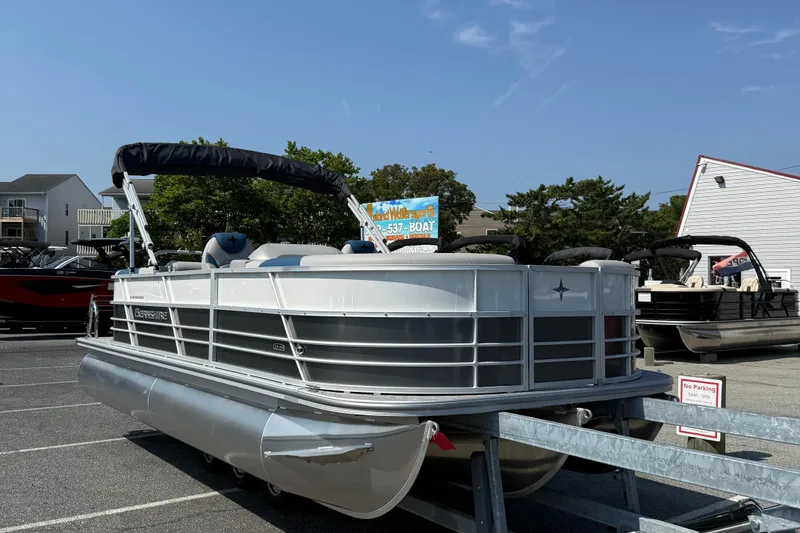 Slide: The Image of 2026 Berkshire 22RFX LE pontoon boat on trailer in parking lot. - 2