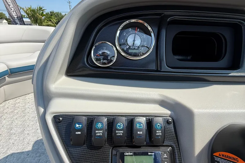 Slide: The Image of Dashboard of 2026 Berkshire 22RFX LE boat with gauges and control switches. - 14