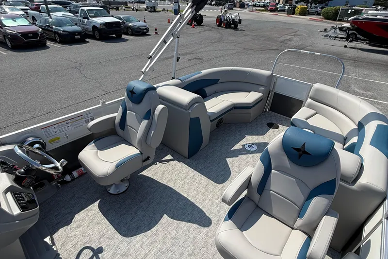 Slide: The Image of 2026 Berkshire 22RFX LE pontoon boat interior with plush seating and modern steering console. - 10