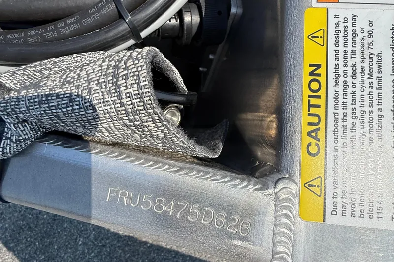 Slide: The Image of Close-up of Berkshire 22RFX LE 2026 boat hull with caution label and serial number. - 17