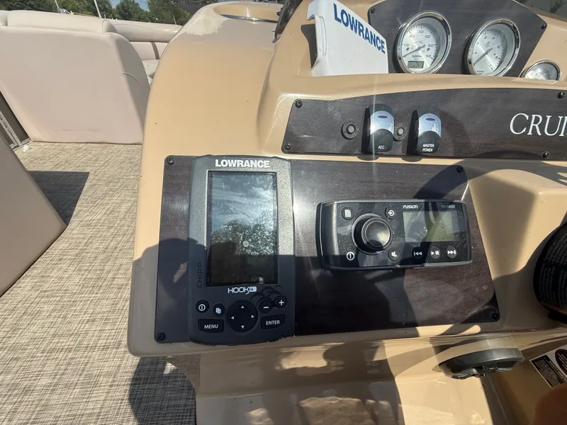 Slide: The Image of The image shows the dashboard of a 2018 Harris 240 CXCS Tritoon with navigation equipment. - 16
