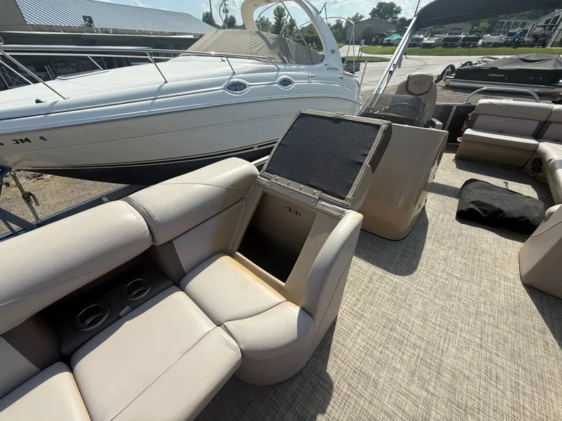 Slide: The Image of Interior of a Harris 240 CXCS Tritoon with beige seating and storage compartment. - 20