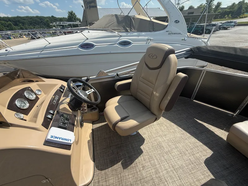 Slide: The Image of The image shows the cockpit of a 2018 Harris 240 CXCS Tritoon with a comfortable captain's chair. - 13