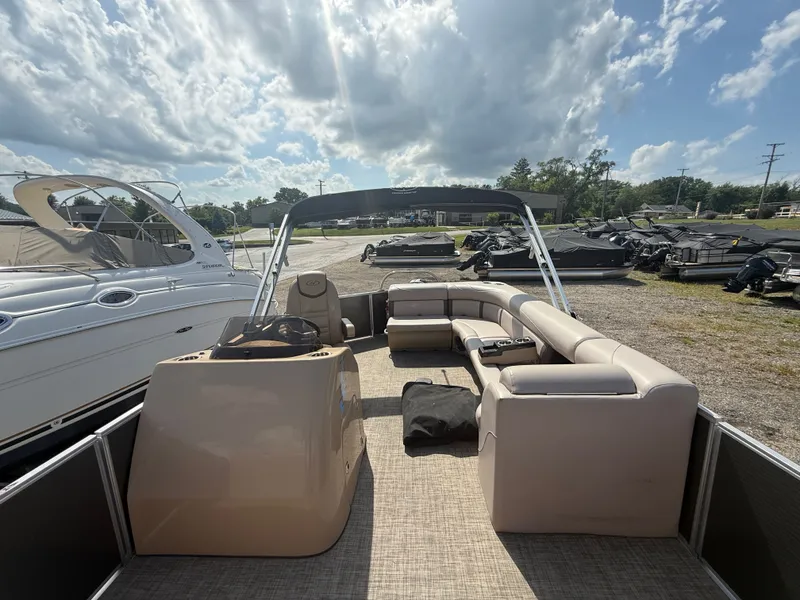 Slide: The Image of A 2018 Harris 240 CXCS Tritoon with beige seating and a sunshade. - 19