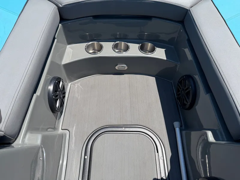 Slide: The Image of The image shows a boat interior with gray upholstery and cup holders. - 9
