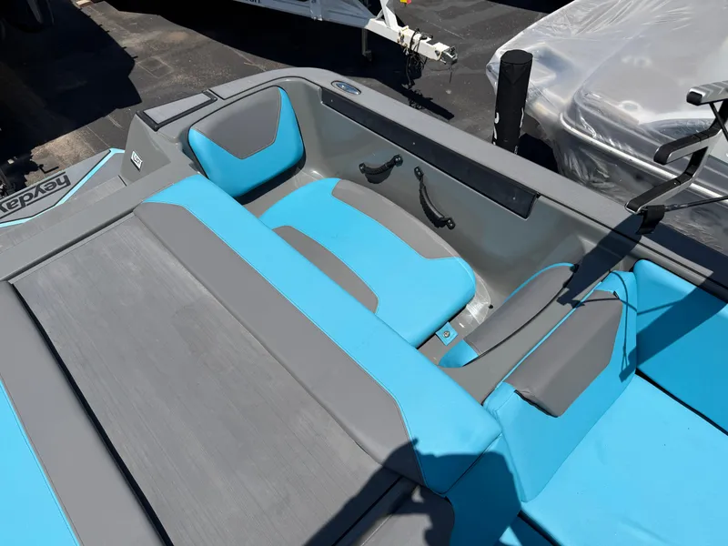 Slide: The Image of The image shows the interior of a 2021 Heyday WT-2DC boat with blue and gray seating. - 22