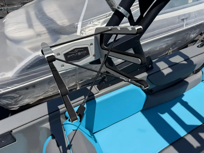 Slide: The Image of Close-up of a boat part with blue upholstery and a PTM Edge mirror mount. - 24