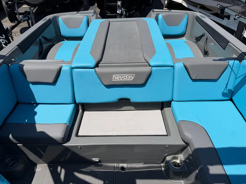 Slide: The Image of The image shows the interior of a 2021 Heyday WT-2DC boat with blue and gray seating. - 32