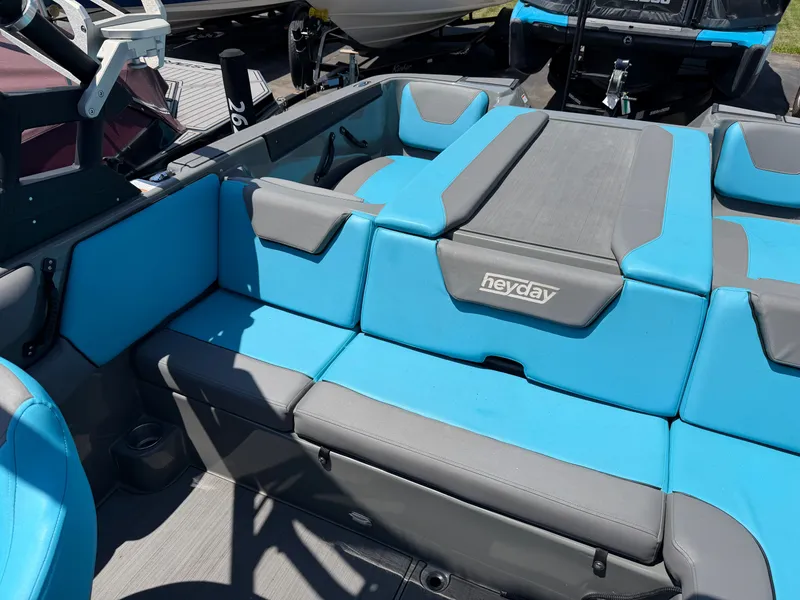 Slide: The Image of The image shows the interior of a 2021 Heyday WT-2DC boat with blue and gray seating. - 18