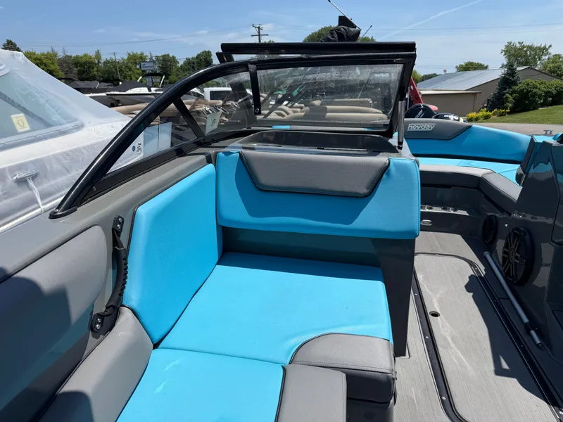 Slide: The Image of The image shows the interior of a 2021 Heyday WT-2DC boat with blue seating. - 11