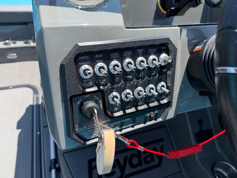 Slide: The Image of Close-up of a Heyday WT-2DC boat's control panel with switches and ignition key. - 15