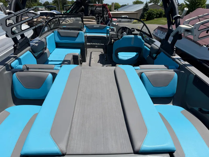 Slide: The Image of The image shows the interior of a 2021 Heyday WT-2DC boat with blue and gray seating. - 28