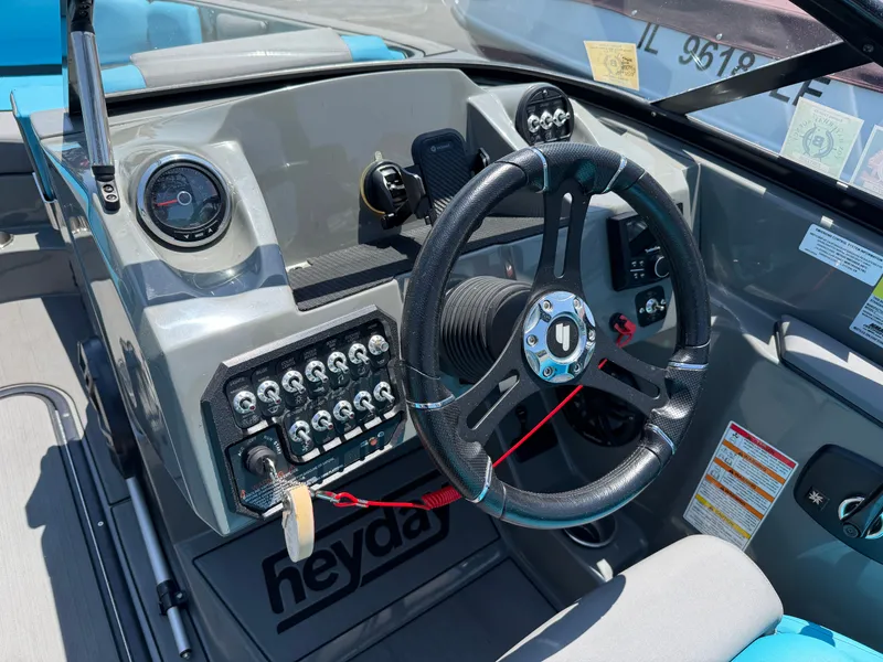 Slide: The Image of The image shows the cockpit of a 2021 Heyday WT-2DC boat with a modern helm. - 12