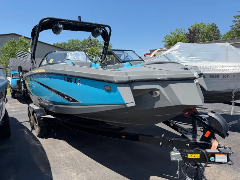 Slide: The Image of A blue and gray 2021 Heyday WT-2DC boat on a trailer in a parking lot. - 2