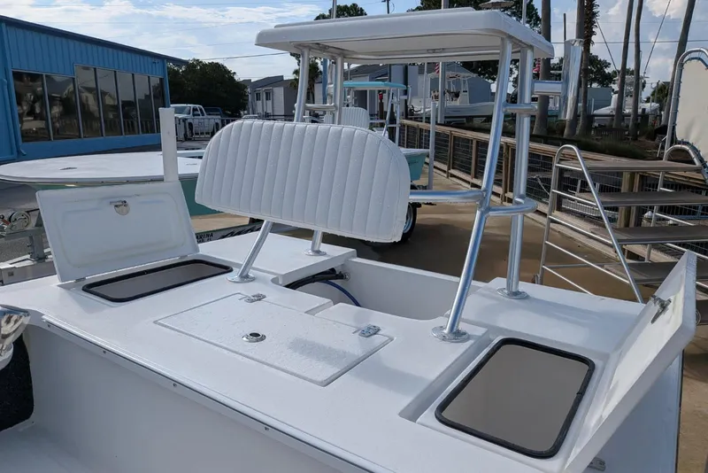 Slide: The Image of 2026 Mitzi Skiffs 17 Tournament boat with open storage compartments and seating. - 5
