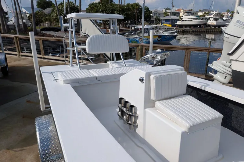 Slide: The Image of 2026 Mitzi Skiffs 17 Tournament boat with sleek white seating and modern design at marina. - 3
