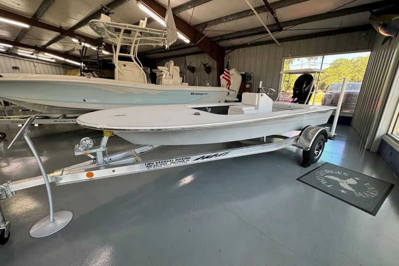 Slide: The Image of 2026 Mitzi Skiffs 17 Tournament boat on trailer in showroom. - 9