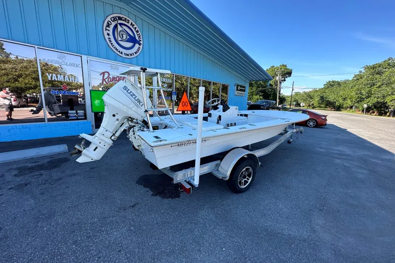 Slide: The Image of 2026 Mitzi Skiffs 17 Tournament boat with Suzuki motor at marina parking lot. - 1