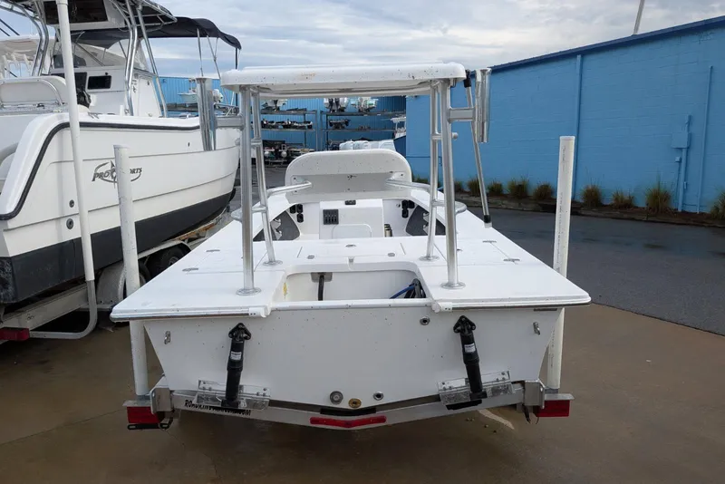 Slide: The Image of 2026 Mitzi Skiffs 17 Tournament boat, docked beside another vessel, in a marina setting. - 4