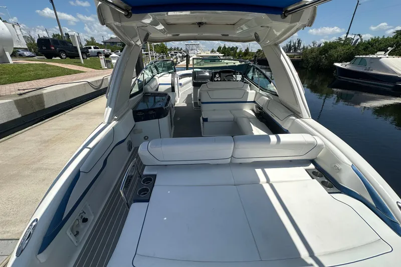 Slide: The Image of 2018 Formula 350 Crossover Bowrider OB with spacious seating and sleek design at dock. - 20