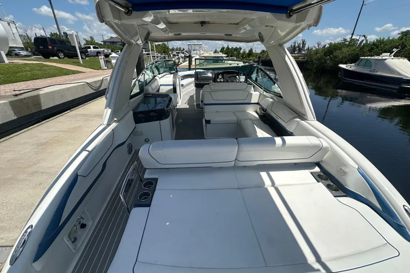 Slide: The Image of 2018 Formula 350 Crossover Bowrider OB with spacious seating and sleek design docked by the water. - 18