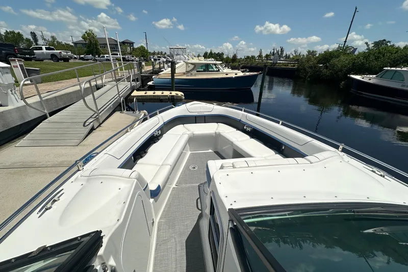Slide: The Image of 2018 Formula 350 Crossover Bowrider OB docked at marina under clear skies. - 17