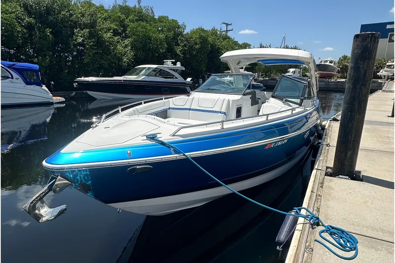 Slide: The Image of 2018 Formula 350 Crossover Bowrider OB docked, featuring sleek blue and white design. - 5