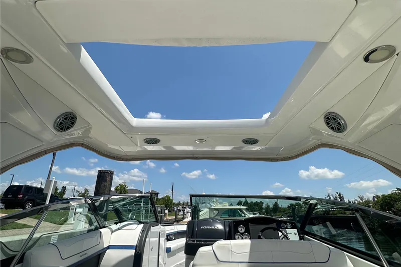 Slide: The Image of 2018 Formula 350 Crossover Bowrider OB interior with open sunroof and clear blue sky. - 21