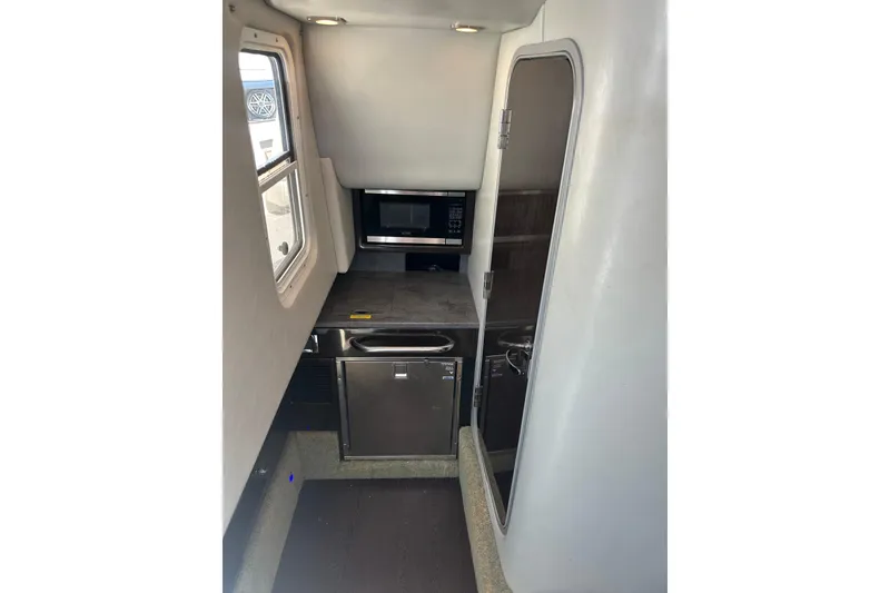 Slide: The Image of Interior of 2018 Formula 350 Crossover Bowrider OB with kitchenette and modern appliances. - 34
