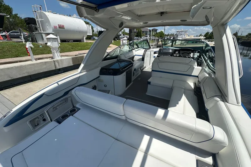 Slide: The Image of 2018 Formula 350 Crossover Bowrider OB with spacious seating and modern design at a marina. - 19