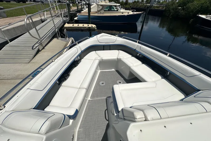 Slide: The Image of 2018 Formula 350 Crossover Bowrider OB with spacious seating at dockside. - 16