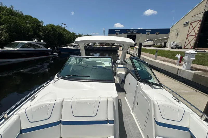 Slide: The Image of 2018 Formula 350 Crossover Bowrider OB docked at marina, showcasing sleek design and spacious seating. - 27