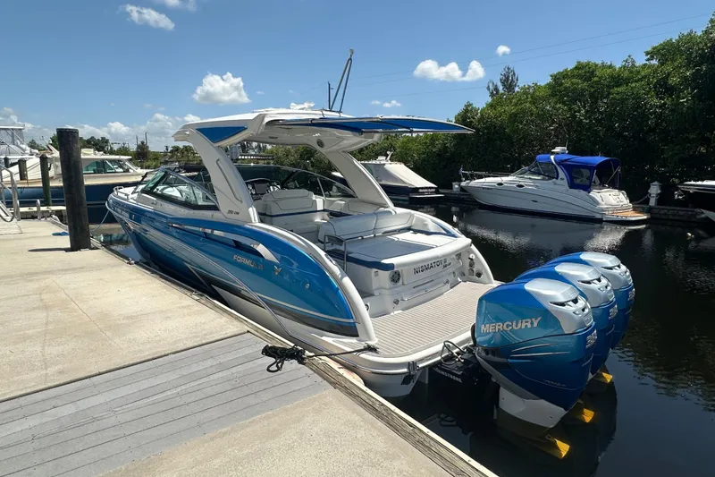 Slide: The Image of 2018 Formula 350 Crossover Bowrider OB with triple Mercury outboards docked. - 9